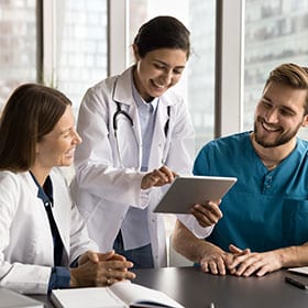Healthcare workers with technology for record management
