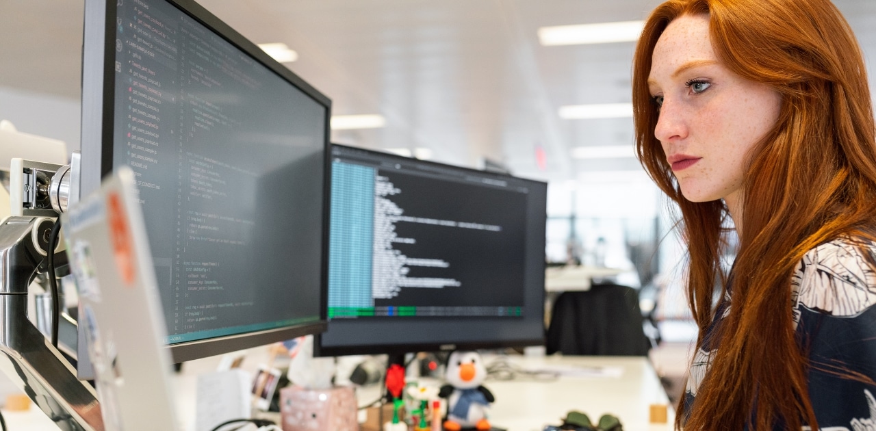 woman developer using vibe coding in a corporate office